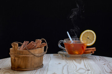 hot cinnamon tea and clove grains on tree table