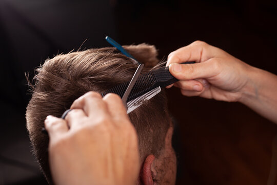 men haircut. hairdressing tools. hair cutting with scissors temporal lobe close-up