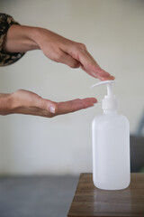 Woman applying hand sanitizer during Coronavirus and flu outbreak. Virus and illness protection. Hands disinfection as prevention of Coronavirus disease.	