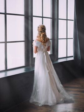  blonde woman in dark old room. Art photography. White dress, without face