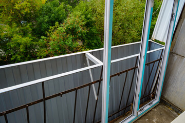 Summer work on installation of plastic frames and double glazing of the balcony close up