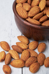 Walnut kernels on a wooden background.Almonds, walnuts and hazelnuts in bowls on a wooden background