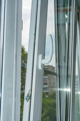 Summer work on installation of plastic frames and double glazing of the balcony close up