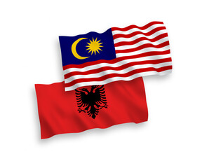 Flags of Albania and Malaysia on a white background