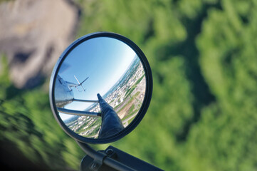 Mid-flight view of the mirror installed on the skid of a helicopter