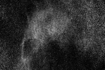 Abstract splashes of water on black background. Freeze motion of white particles. Rain, snow overlay texture.