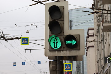 The traffic light shows a green light and a right turn. Regulation of the movement of cars.