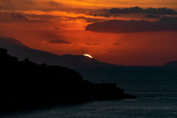Italy, Campania, Sorrento - 16 August 2019 - The sun goes down behind the mountains at sunset from Sorrento