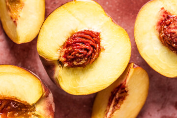 Fresh and juicy peaches halved and sliced. Close-up view.