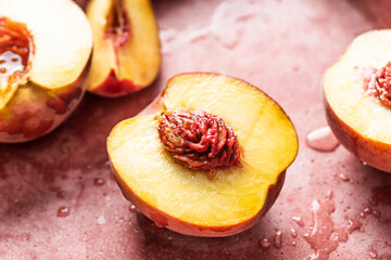 Fresh and juicy peaches halved and sliced. Close-up view.