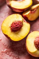 Fresh and juicy peaches halved and sliced. Close-up view.