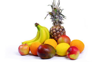 Citrus fruits, lemon, mango, banana, orange and pineapple on a white background