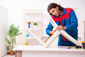 Young male carpenter working indoors