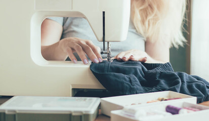 Woman's hands working on a sewing machine