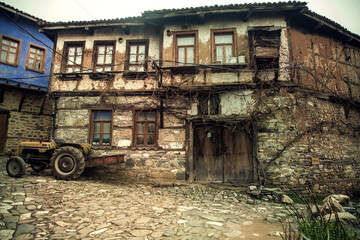 Old ancient village house and a tractor in Cumalıkizik village, Bursa (Turkey)