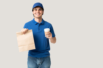 Fototapeta na wymiar Smiling Delivery Man In Uniform Holding Parcel
