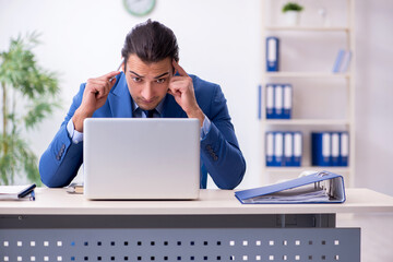 Young male employee in the office