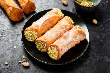 Sweet homemade cannoli stuffed with ricotta cheese  and pistachio. Sicilian dessert. Italian pastry.