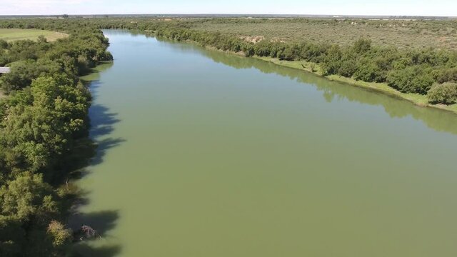 Aerial view of the Vaal river with lush riverine vegetation in an arid region of the Northern Cape, South Africa 