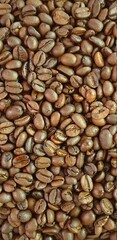 Roasted coffee beans brown background