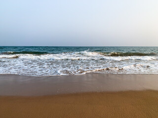 wide view of sea sore with waves and  cloudy sky in the evening 