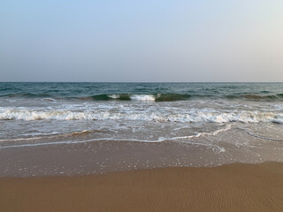 wide view of sea sore with waves and  cloudy sky in the evening 
