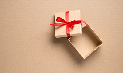 Empty open gift cardboard box on a cardboard background. top view
