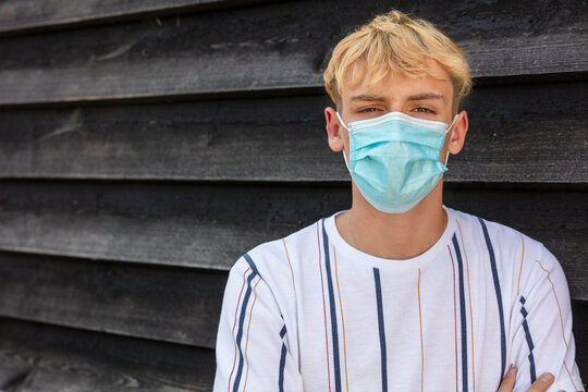 Boy Teenager Teen Male Young Man Wearing Face Mask In The Coronavirus COVID-19 Pandemic