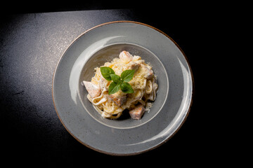 Italian fettuccine pasta with salmon in a creamy sauce