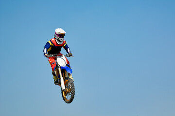 motocross rider jumping on a motorcycle