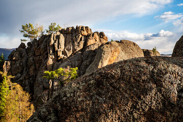 Rocks with pine trees against the sky, spring