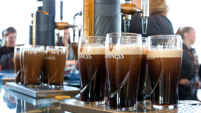 DUBLIN, IRELAND - FEB 15, 2014: Pints of beer are served at the Guinness Brewery. The brewery where 2.5 million pints of stout are brewed daily was founded by Arthur Guinness in 1759.
