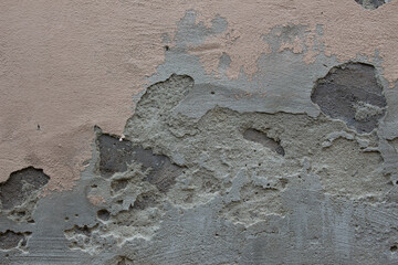 Old dirty weathered wall with layers of plaster falling off ready for repair