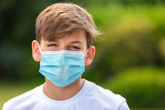 Boy Teenager Teen Male Child Wearing Face Mask Outside In The Coronavirus COVID-19 Pandemic