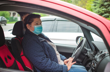 Social distance in citizens life, woman in a car, on the street