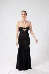 Fototapeta premium Pretty woman in a formal black dress