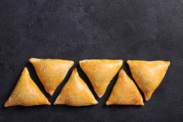 Very tasty samosa on a black background, top view. Place for text