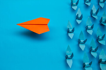 orange paper plane pass all blue paper birds with high speed, speed win scale, innovation and think the different concept
