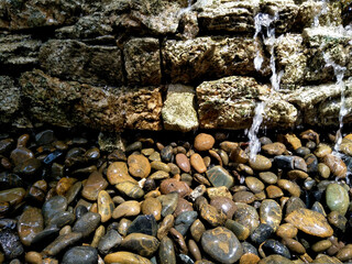 Water is flowing through stones, use as background.