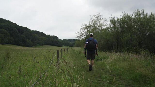 A man walking through the English countryside