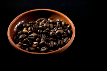 coffee in a clay cup on black velvet