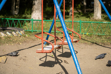 Very old swing for children. Old playground.