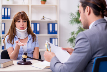 Young injured woman and male lawyer in the courtroom