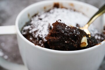 Microwave  Chocolate mug cake under one minute, selective focus