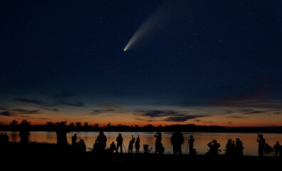 Comet Neowise comet C/2020 F3 (NEOWISE) and crowd of people silhouetted by the Ottawa river...