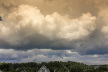 Landscape with a stormy sky and picturesque clouds over the village