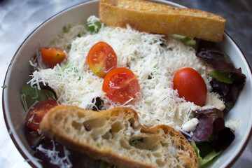 fresh salad topped with Parmesan 