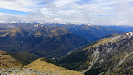 View over the Haast Pass from the summit of Mt Armstrong on the Brewster Track looking out over Mount Aspiring National Park, South Island, New Zealand.