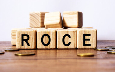 wooden cubes and ROCE, coins, the concept of taxation, increase taxes and fees