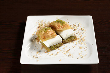 Turkish sweetness puff baklava with ice cream, two baklava on a plate. Photos for restaurant and cafe menus